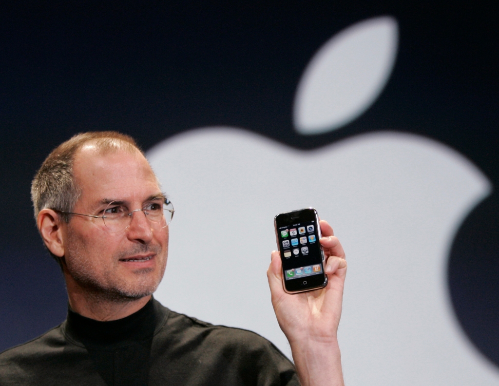 Apple CEO Steve Jobs holds up an iPhone in 2007.